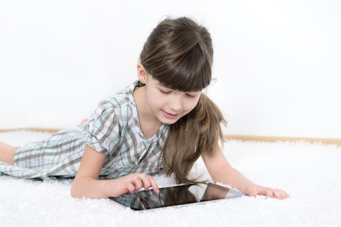stock photo 23514521 little girl playing with a tablet