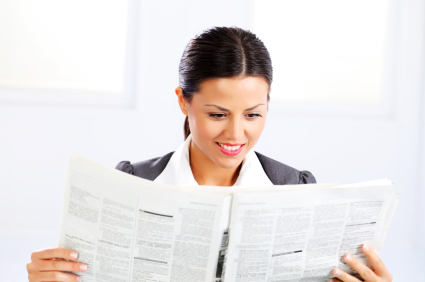 business woman reads a newspaper