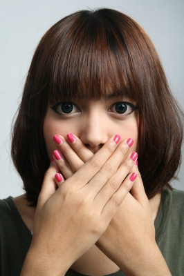 woman covering mouth