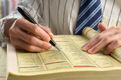 businessman searching in yellow pages