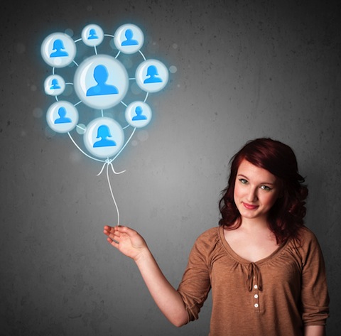 young woman holding social network balloon