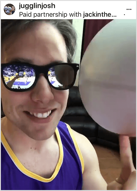 Josh Horton posts a photo for a campaign with Jack in the Box and the LA Lakers. Josh wears mirrored sunglasses and a Lakers jersey and is smiling for the camera while spinning a ball.