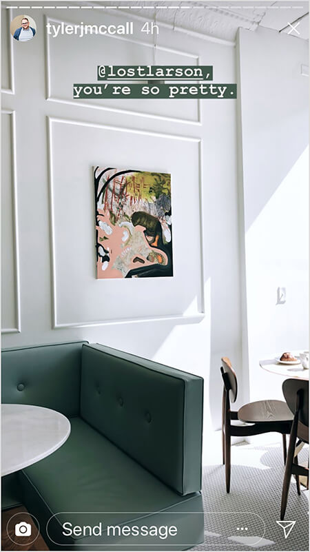 Tyler J. McCall posts a photo in the middle his day-in-the-life story arc. The photo shows the interior of Lost Larson, with a green couch, a white marble-topped table, a white tile floor, and pale walls with art hung inside a square of white wood trim on a pale gray wall. Text on the post says “@lostlarson, you’re so pretty” as a reminder that his story includes a trip to Lost Larson.