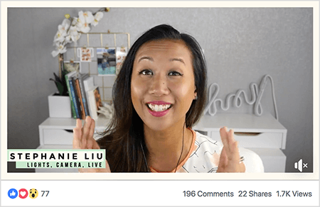 This is a screenshot of Stephanie Liu in a Facebook live video. Viewers can see Stephanie from the shoulders up. Stephanie is an Asian woman with black hair hanging just below her shoulders. She’s smiling and wearing makeup and a white shirt with a peach and black abstract pattern. In the lower left, on a light green background is the black text “Stephanie Liu, Lights Camera Live”. The background for her live video is a gray room with a white desk. On the desk are books and a white orchid in a square white pot. A white neon sign that spells “hey” is also sitting on the desk, and it’s turned off. The live video has 77 reactions, 196 comments, 22, shares, and 1.7K views.