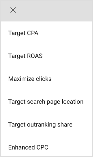 This is a screenshot of a menu of targeting options in Google Ads. The options are Target CPA, Target ROAS, Maximize clicks, Target search page location, Target outranking share, Enhanced CPC. Mike Rhodes says smart targeting options in Google Ads use artificial intelligence to find people with the right intent for your ad.