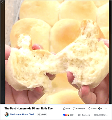 This is a screenshot of a video “The Best Homemade Dinner Rolls Ever” from The Stay At Home Chef Facebook page. The video still shows the hands of a white person tearing open a fresh-baked roll. A tray of these rolls is in the background. Below the video still is the video title and the Facebook page name. The video has 239K reactions, 23K comments, and 2,262,860 shares. Rachel Farnsworth posted this video to her page after spending time offline studying how to create online video and making videos for other pages.