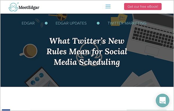 This is a screenshot of a blog post image from the MeetEdgar website. The image has a dark background with an overhead illustration of a coffee cup, an laptop, papers, and the MeetEdgar octopus logo. In white text over this image is the text “What Twitter’s New Rules Mean for Social Media Scheduling”. Above this image is the MeetEdgar octopus logo, a hamburger menu, and a pink button labeled “Get Our Free Ebook!”. In the lower right is a chat icon.