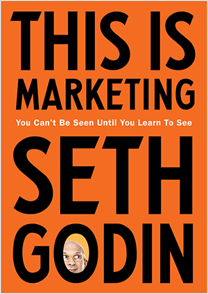 This is a screenshot of the cover of This Is Marketing by Seth Godin. The cover is a vertical rectangle with an orange background and black text. A photo of Seth’s head appears in the O of his last name.