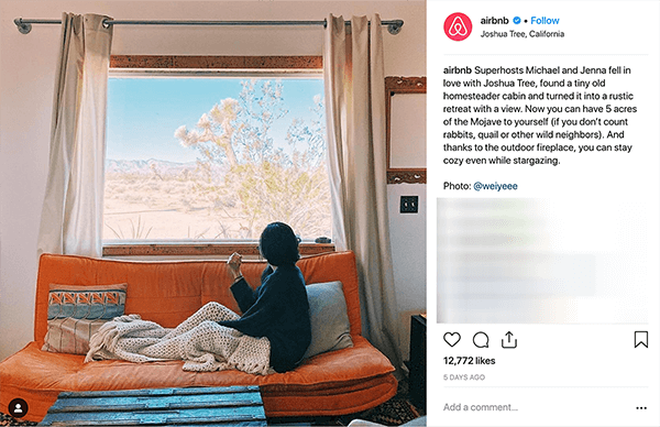 This is a screenshot of an Instagram post from Airbnb. It tells the story of a couple who hosts people at their home through Airbnb. In the photo, someone sits on an orange couch under a beige knitted throw blanket and looks out the window at a desert landscape. Melissa Cassera says these stories are an example of a business using the overcoming the monster plotline in its social media marketing.