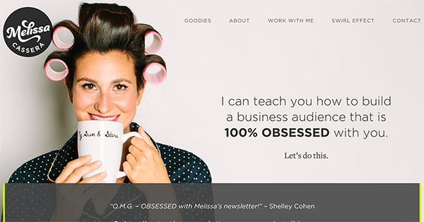 This is a screenshot of Melissa Cassera’s website. Her logo appears in the upper left. On the left side of the page is photo of Melissa. She’s a white woman with dark hair, smiling and drinking a cup of coffee. She’s wearing large rollers in her hair and a dark blue pajama top with small white polka dots. On the right is the text “I can teach you how to build a business audience that is 1005 OBSESSED with you. Let’s do this.”