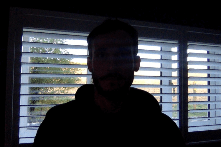 silhouette effect created when subject of video is standing in front of window